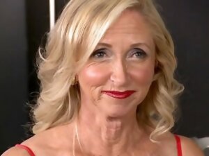 Blonde 50 plus lady poses with her toyboy